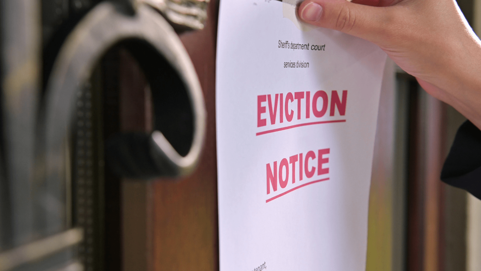 Eviction notice posted on a homeowner’s door raising the question can an HOA evict you.